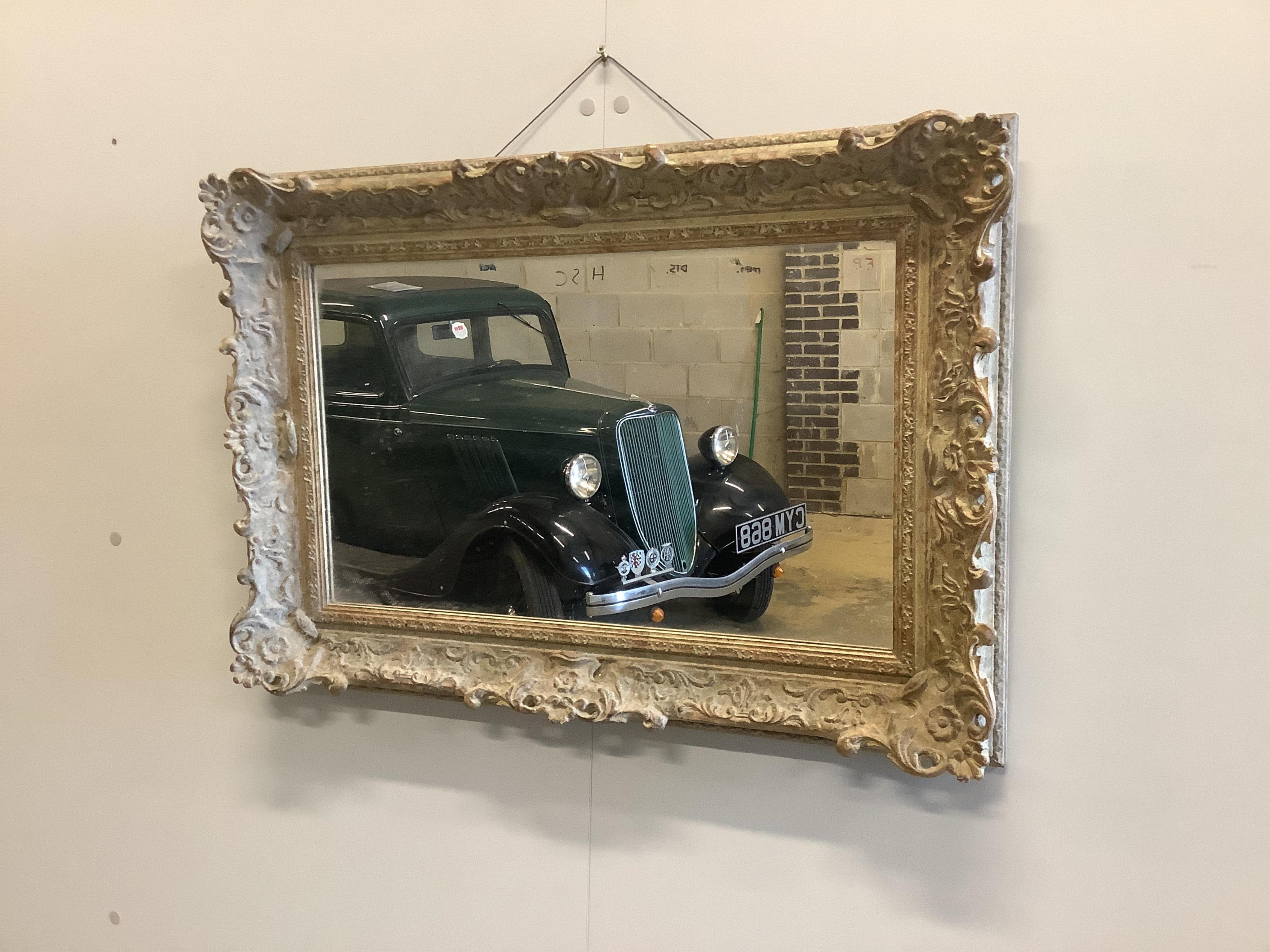 A Victorian style gilt composition rectangular wall mirror, width 73cm, height 51cm. Condition good.